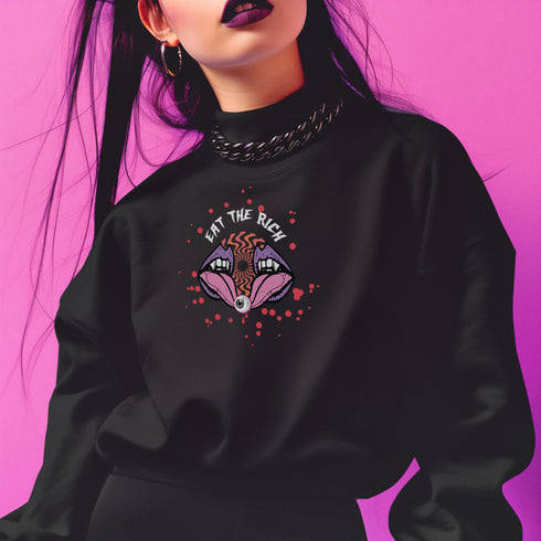 a black sweatshirt featuring a psychedelic "Eat the Rich" design with an eyeball and vampire teeth,